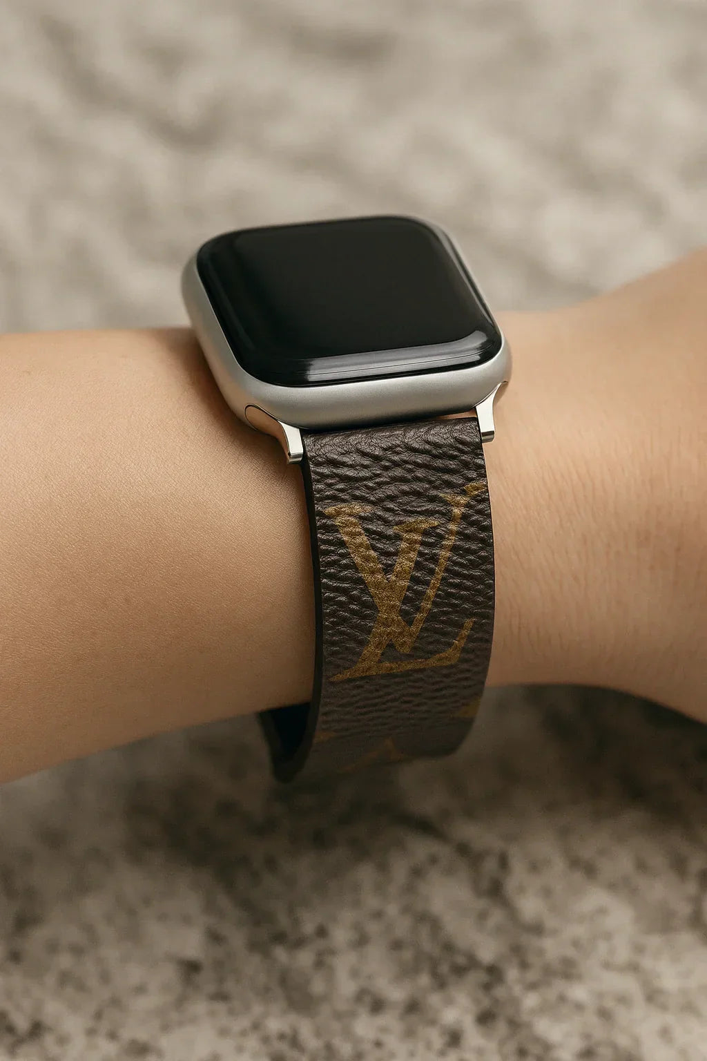 Close-up of an authentic repurposed designer Apple Watch band made from upcycled monogram canvas, highlighting the real texture and craftsmanship for the ‘Authenticity Matters’ guide.