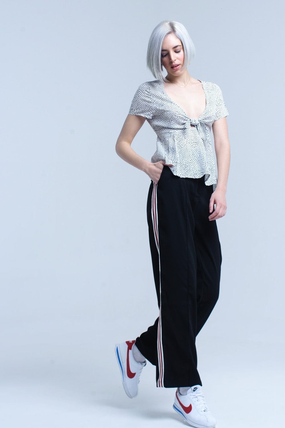 Q2 Women's Blouse White polka dot top with ruffle hem